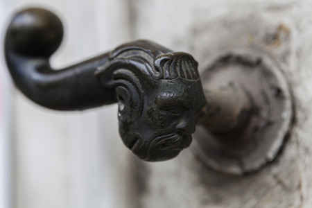 Human figure old brass door ahndle on ancient white doorの写真素材