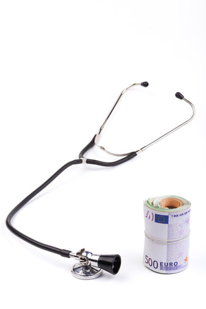 Black stethoscope  closeup with euro  isolated on white backgroundの写真素材