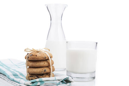 Milk and Cookies in bottle and glass isolated on white backgroundの写真素材