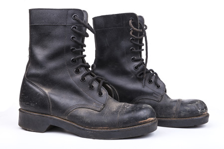 Pair of Black Dirty army boots isolated on white background