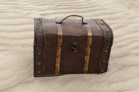 Treasure chest in sand dunes on a beach