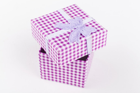 Pink jewelry ring cardboard box with pattern and ribbon isolated on white backgroundの写真素材