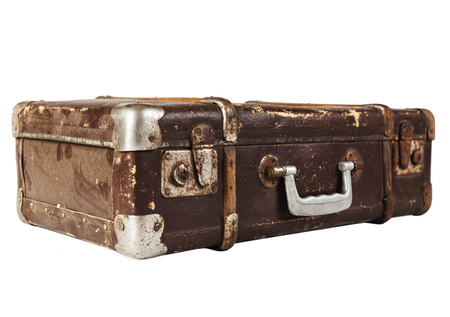 Old Brown used and weathered suitcase isolated on white backgroundの写真素材