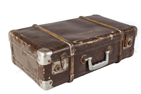Old Brown used and weathered suitcase isolated on white backgroundの写真素材