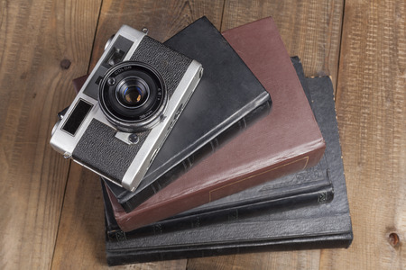 Old Camera Closeup on old Books and Brown Wood Backgroundの写真素材