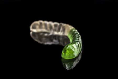 Jelly worm isolated on black background with reflexionの写真素材