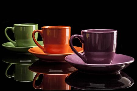 Cups isolated on black background with reflexionの写真素材