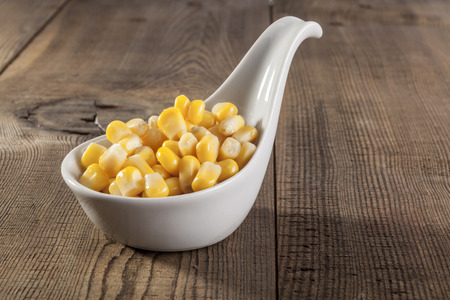 Sweet yellow corn beans on wood tableの写真素材
