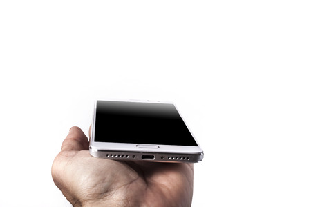 Phone in hand isolated on white backgroundの写真素材