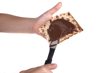 Child Hand Making Passover Sweets Isolated on White