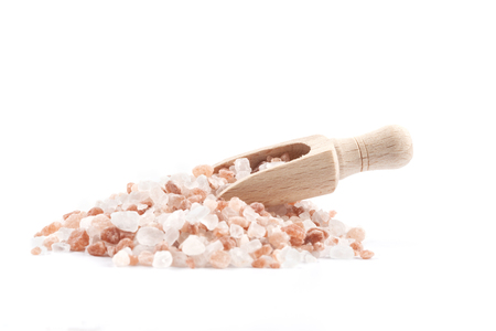Himalayan Salt Raw Crystals Pile with Brown Wood Spice Scoop Isolated on White Backgroundの写真素材