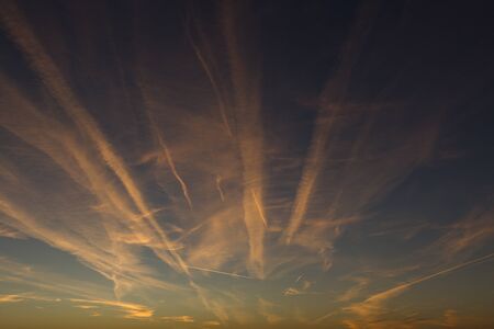 Airplane Trails on Morning Sunrise Cloudy Skyの写真素材