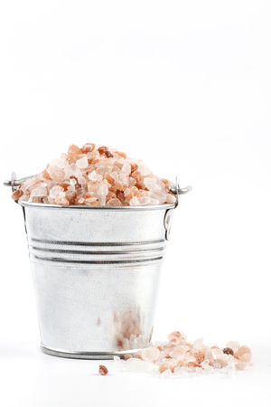 Himalayan Salt Raw Crystals Pile in Silver Metal Bucket Isolated on White Backgroundの写真素材