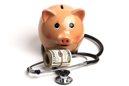 Cute Piggy Bank With Black Stethoscope and Dollar Banknotes Roll Isolated on White Backgroundの写真素材