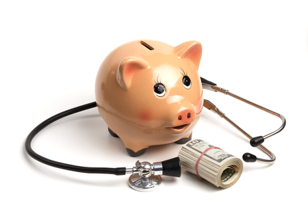Cute Piggy Bank With Black Stethoscope and Dollar Banknotes Roll Isolated on White Backgroundの写真素材