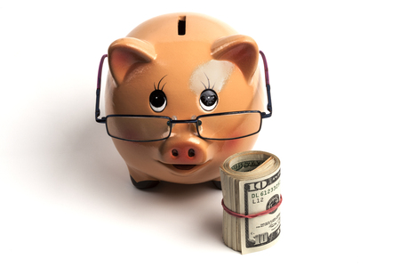 Piggy Bank With Dollars Roll and Calculator Isolated on White Backgroundの写真素材
