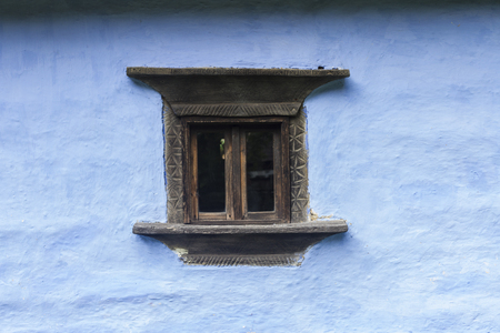 Carved Old Wood Window on blue houseの写真素材