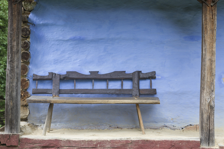 Old Log house with wood benchの写真素材