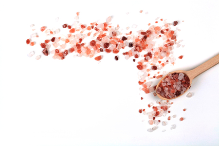 Himalayan Salt Cristals Frame With Brown Wood Spoon Isolated on White Backgroundの写真素材