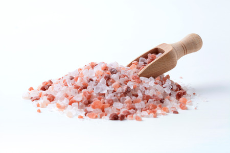 Wooden Spice Spoon In a Pile of Himalaya Salt Isolated on White Backgroundの写真素材