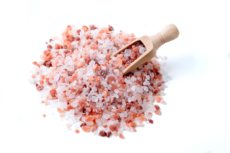 Wood Spoon in a Pile of Himalaya Salt Isolated on White Backgroundの写真素材