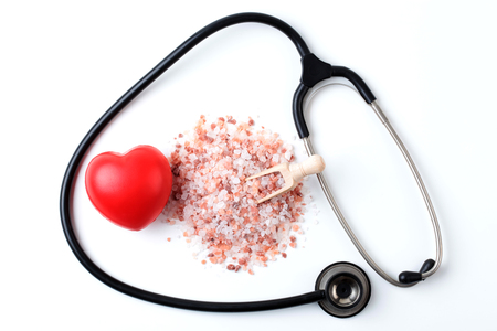 Red Heart with Black Stethoscope and Salt Isolated on White Backgroundの写真素材