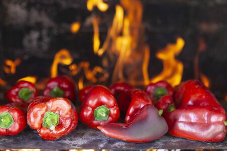 Barbequed red peppers with hot flames in the backgroundの写真素材