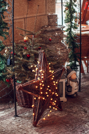 Christmas decoration in the form of a star on the background of the Christmas treeの写真素材