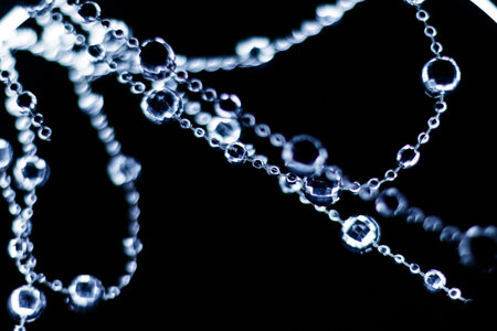 Crystal beads garland hanging and shining on a dark background for christmas or new year celebration