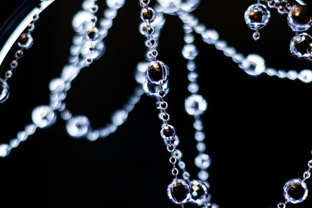 Crystal beads garland hanging and shining on a dark background for christmas or new year celebration