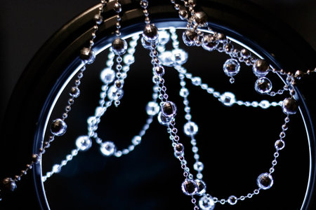 Crystal beads garland hanging and shining on a dark background for christmas or new year celebration