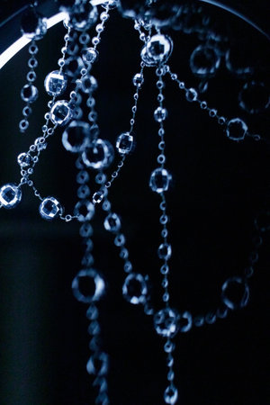 Crystal beads garland hanging and shining on a dark background for christmas or new year celebration