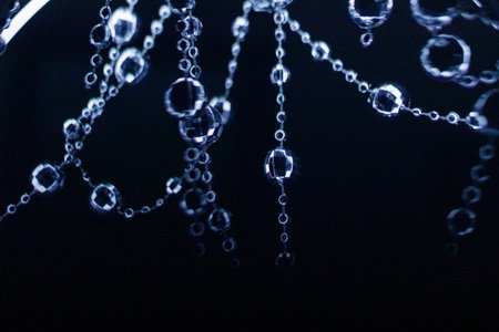 Crystal beads garland hanging and shining on a dark background for christmas or new year celebration