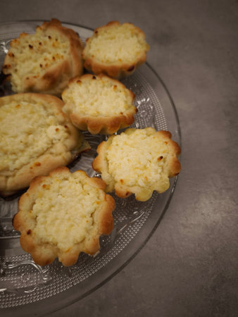 Freshly baked mini cheesecakes, sitting on a decorative glass plate, offer a tempting treat copy spaceの写真素材