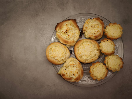 Freshly baked vatrushka buns, filled with sweet cottage cheese, are served on a glass plate in Prague, czechia copy spaceの写真素材