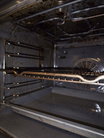 Interior of a very dirty domestic oven showing layers of burned on grease and foodの写真素材