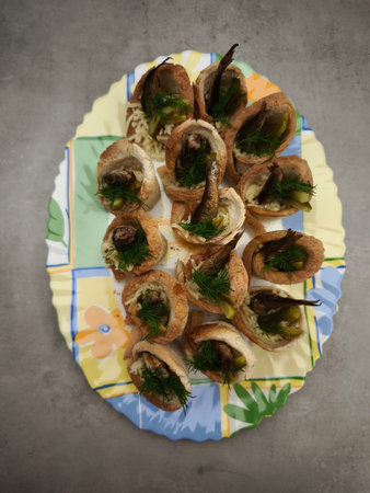 Bread cups filled with sprats, pickles, dill, and cheese, creating a festive Christmas appetizer on...