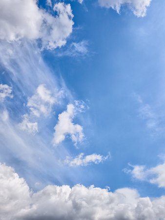 Beautiful white clouds are streaking across a vibrant blue sky, creating a picturesque and serene...