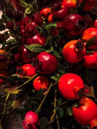 Vivid arrangement of fresh red fruits and green leaves, showcasing the beauty of nature's bounty with rich colors and texturesの写真素材