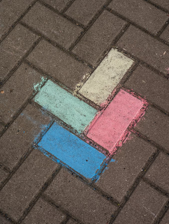Colorful chalk arrow guiding the way on cobblestone street