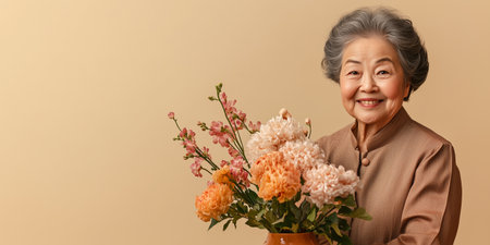 Asian Elderly woman holding colorful flowers bouquet for valentines dayの素材
