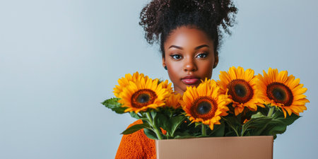 African American Florist holding sunflowers in cardboard box for valentines dayの素材