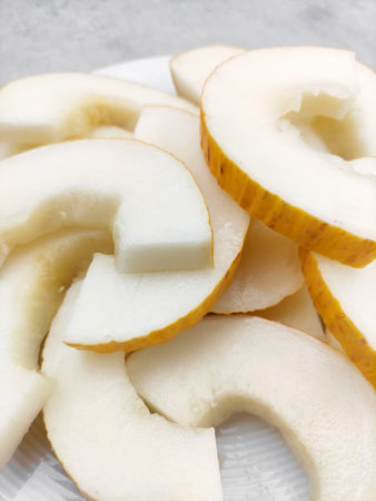 Sliced korean melon on white plate displaying refreshing pulpの写真素材
