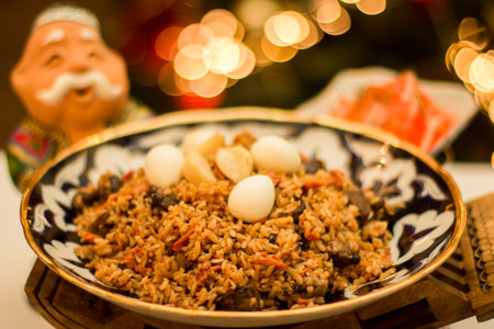 A vibrant pilaf Uzbek rice dish is beautifully presented in a decorative bowl, showcasing tender meat, fragrant spices, and quail eggs, creating an inviting culinary experienceの写真素材