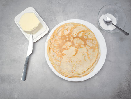 Celebrating pancake day with delicious homemade crepes, butter, and sugar in prague for shrove...