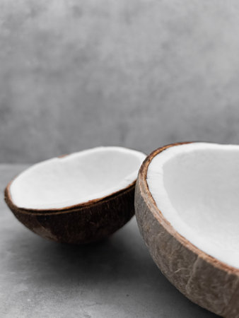 Two empty coconut halves resting on gray surface. Copy space, bannerの写真素材