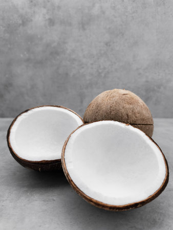 Fresh coconuts showing white flesh on gray background. Copy space, bannerの写真素材
