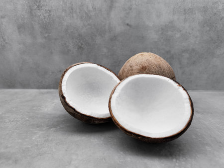 Fresh coconuts showing white flesh on gray background. Copy space, bannerの写真素材