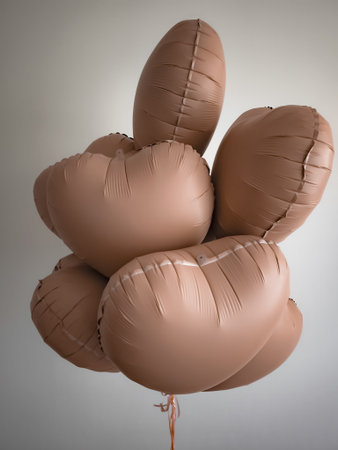 Brown heart shaped mocha mousse balloons floating for valentines day, anniversary or weddingの写真素材