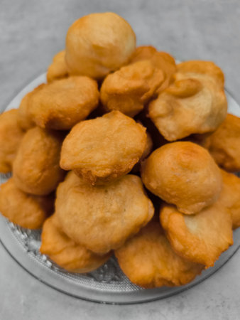 Freshly made baursaki piled high on glass plate in pragueの写真素材